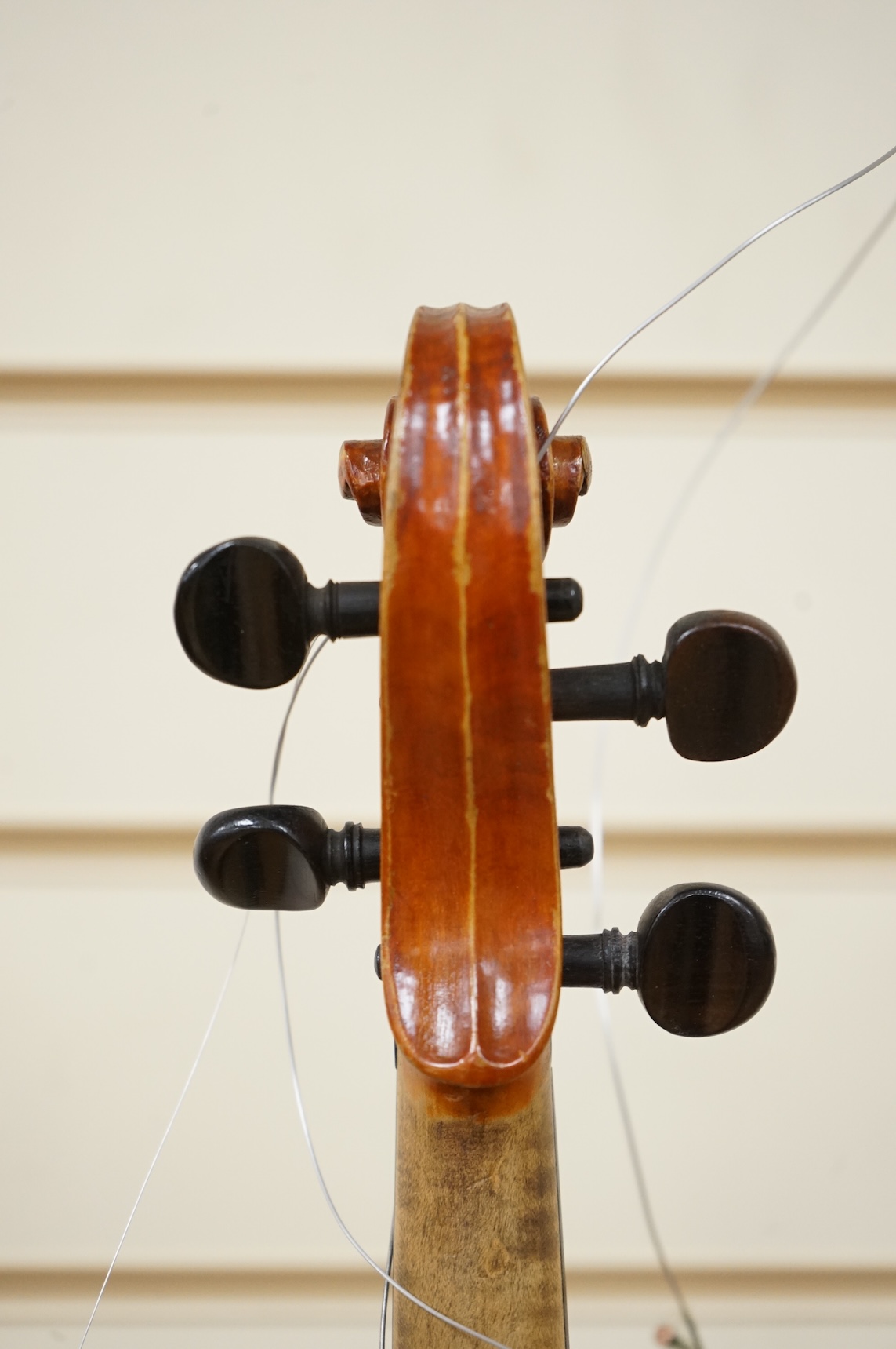 Four violins; a German Dresden violin, together with further two German violins, and a Saxony violin, three in cases or the remains of cases.